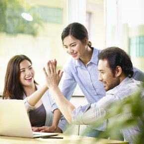 Young,Asian,Business,Person,Giving,Coworker,High,Five,In,Office